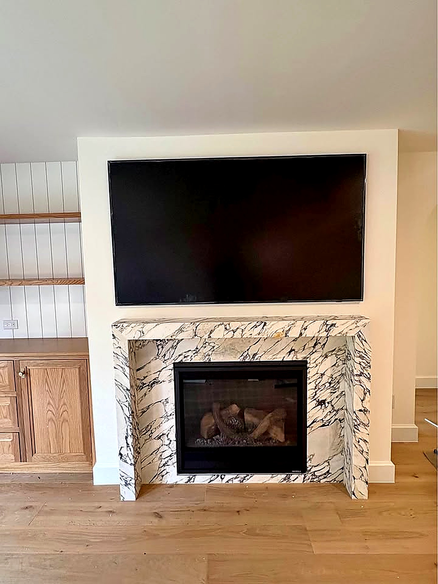 Mounted TV above fireplace in a Houston home